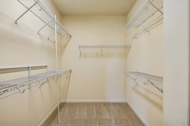 an empty room with window and ceiling fan