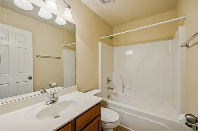 a view of a livingroom with a ceiling fan and window