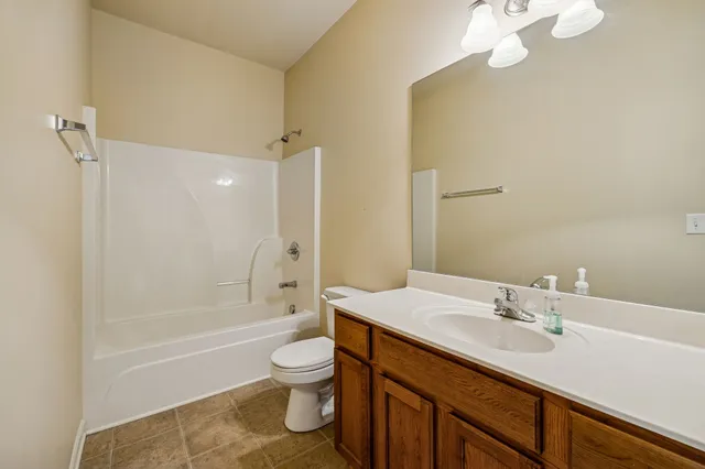 a view of an empty room window and a kitchen area