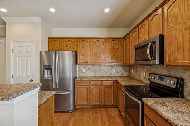 a kitchen with a sink stove and refrigerator