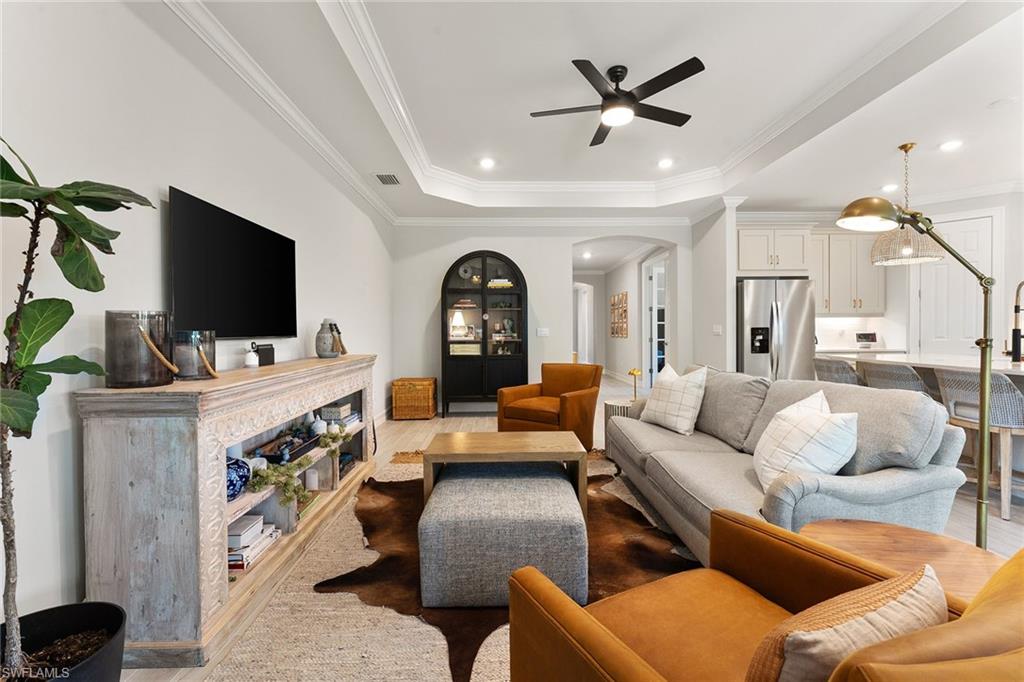 394 Deauville Loop Naples, FL 34114 - Photo 13 of 50 a living room with furniture and a flat screen tv