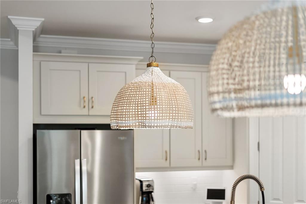 394 Deauville Loop Naples, FL 34114 - Photo 15 of 50 a close view of kitchen appliances with cabinets