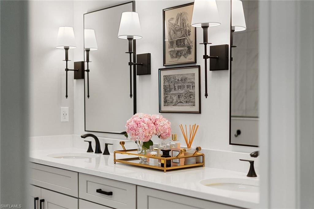 394 Deauville Loop Naples, FL 34114 - Photo 19 of 50 a bathroom with a sink and a mirror