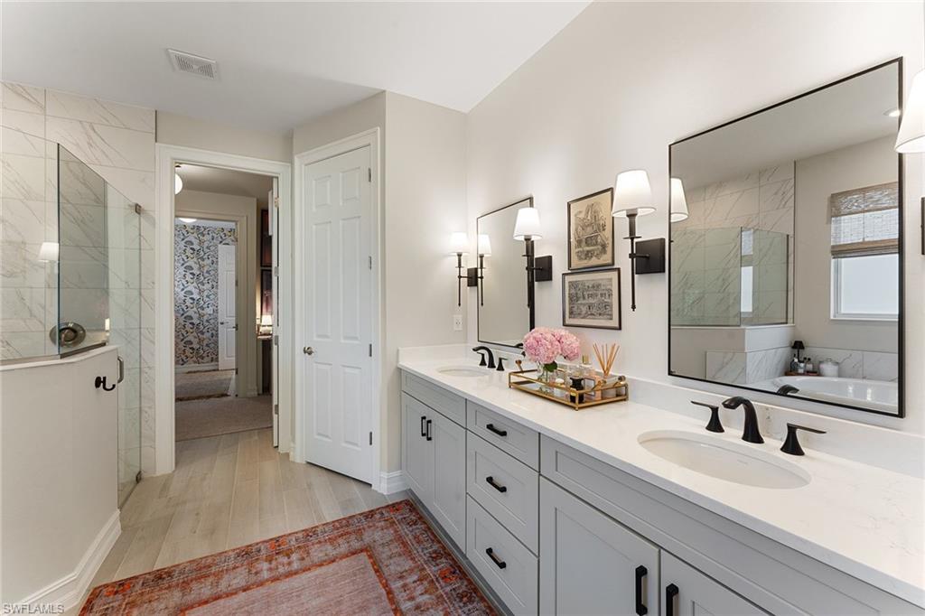 394 Deauville Loop Naples, FL 34114 - Photo 20 of 50 a spacious bathroom with a double vanity sink mirror and shower
