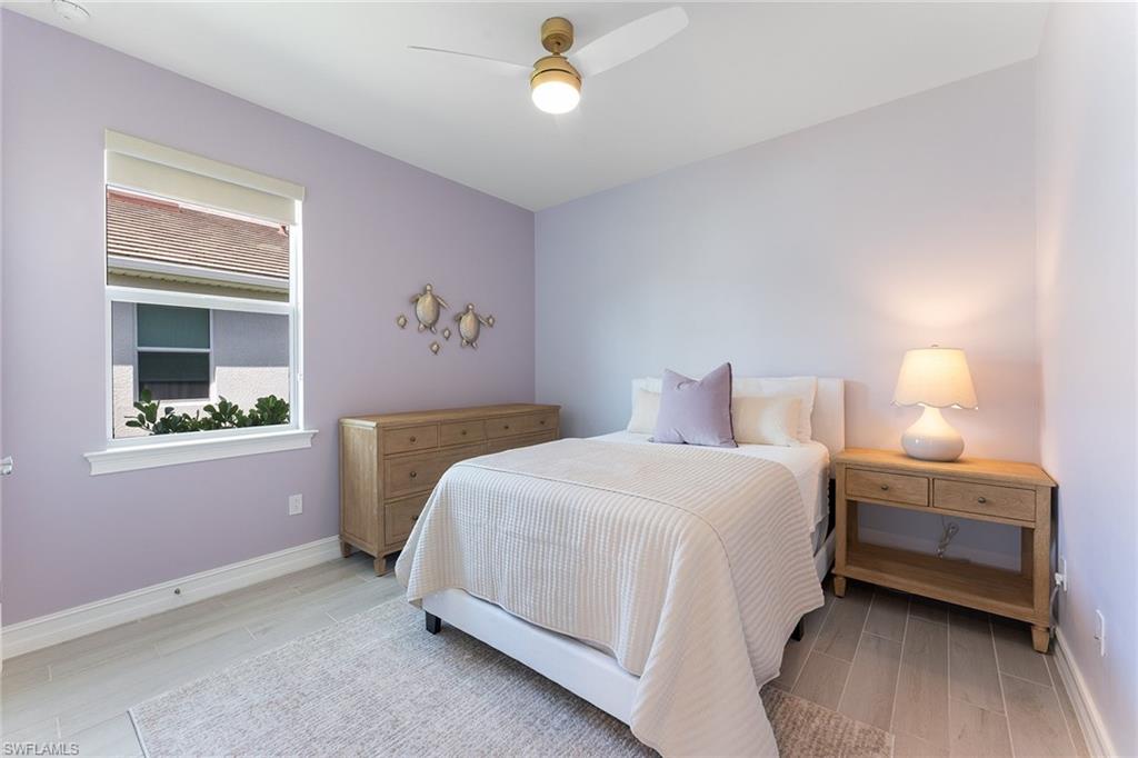 394 Deauville Loop Naples, FL 34114 - Photo 27 of 50 a bedroom with a bed and a lamp