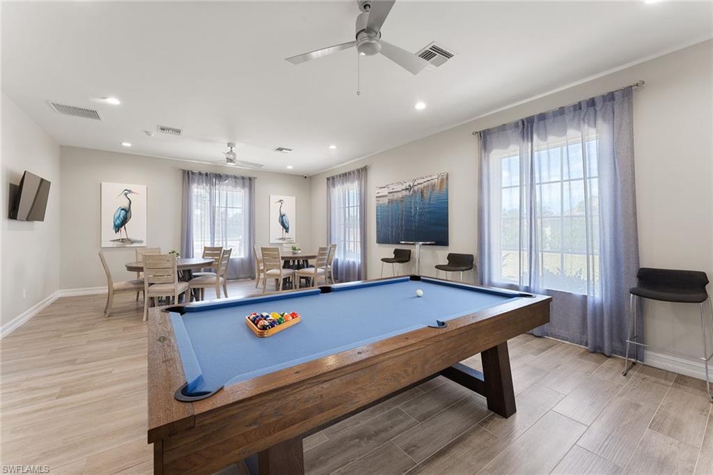 394 Deauville Loop Naples, FL 34114 - Photo 39 of 50 a room with pool table and windows