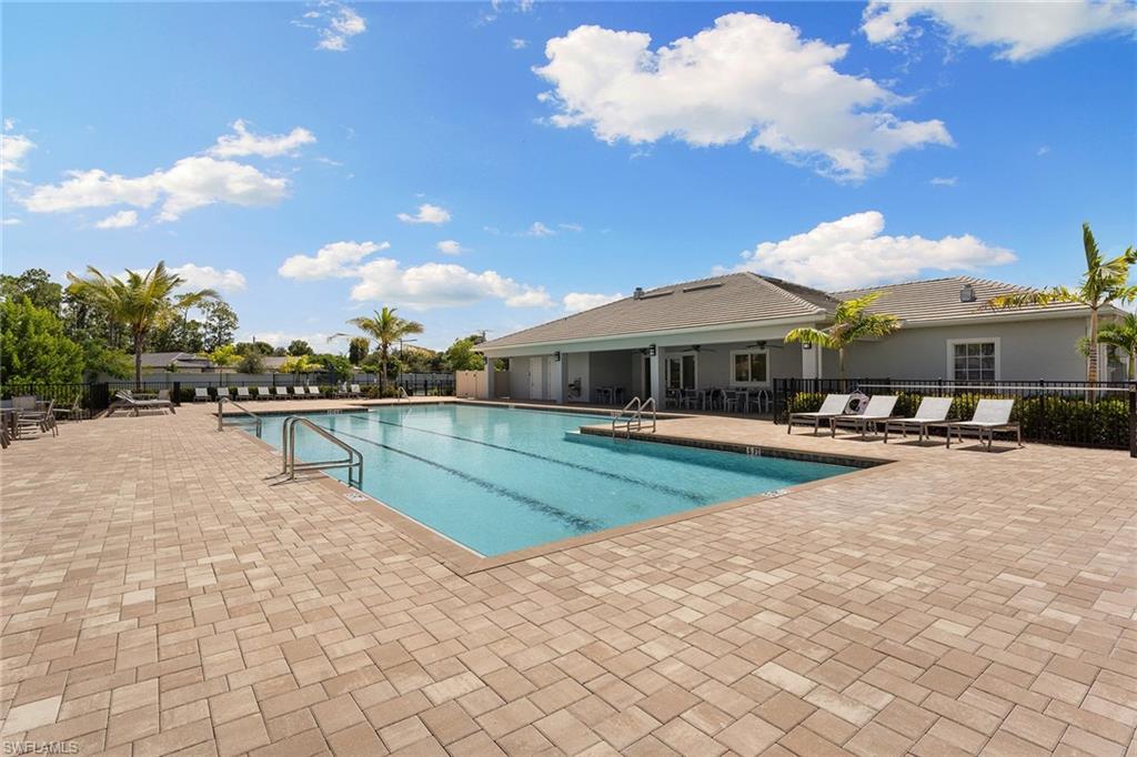 394 Deauville Loop Naples, FL 34114 - Photo 41 of 50 a swimming pool with outdoor seating and yard