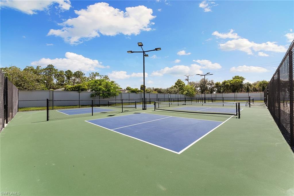 394 Deauville Loop Naples, FL 34114 - Photo 43 of 50 a view of a tennis court