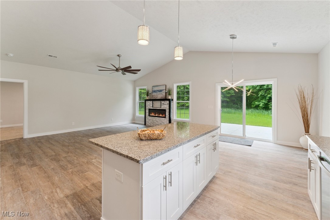 7605 Lake Road East Madison, OH 44057 - Photo 14 of 50 Kitchen featuring light wood-style flooring, plenty of natural light, decorative light fixtures, ceiling fan, and lofted ceiling