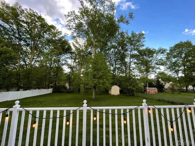 a view of a wooden fence and trees
