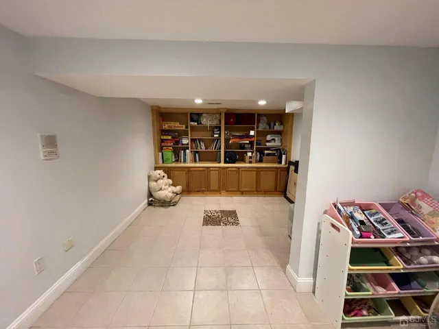 a living room with a bed and a flat screen tv