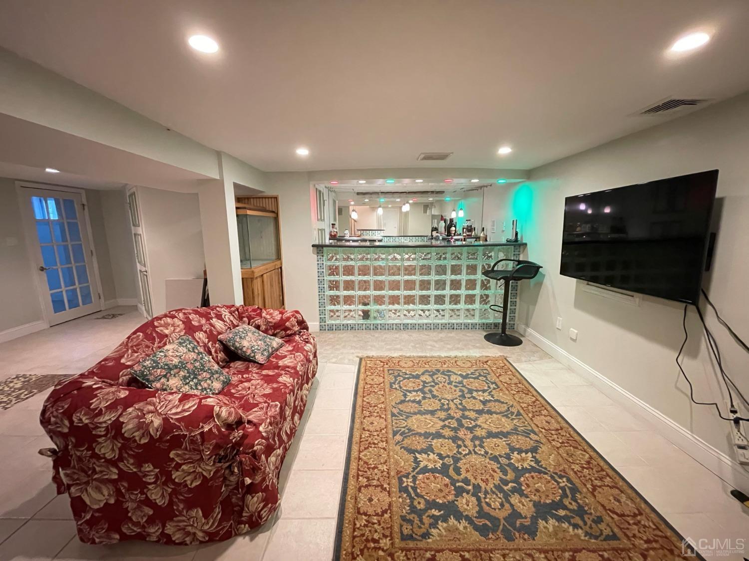 12 Ramsey Road Edison, NJ 08820 - Photo 27 of 30 a living room with a bed and a flat screen tv