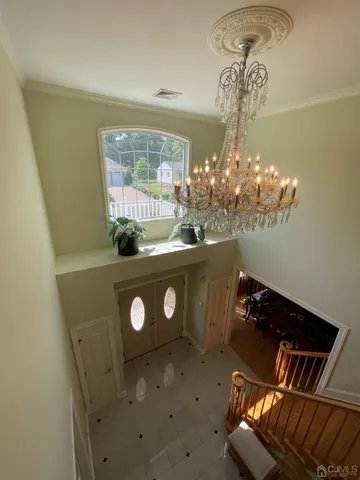a view of a dining room with furniture and chandelier