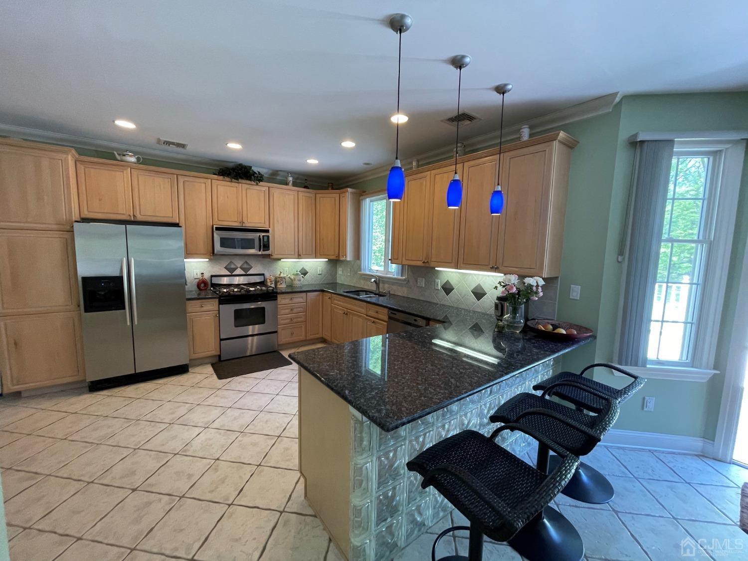12 Ramsey Road Edison, NJ 08820 - Photo 10 of 30 a kitchen with granite countertop a sink stainless steel appliances and cabinets