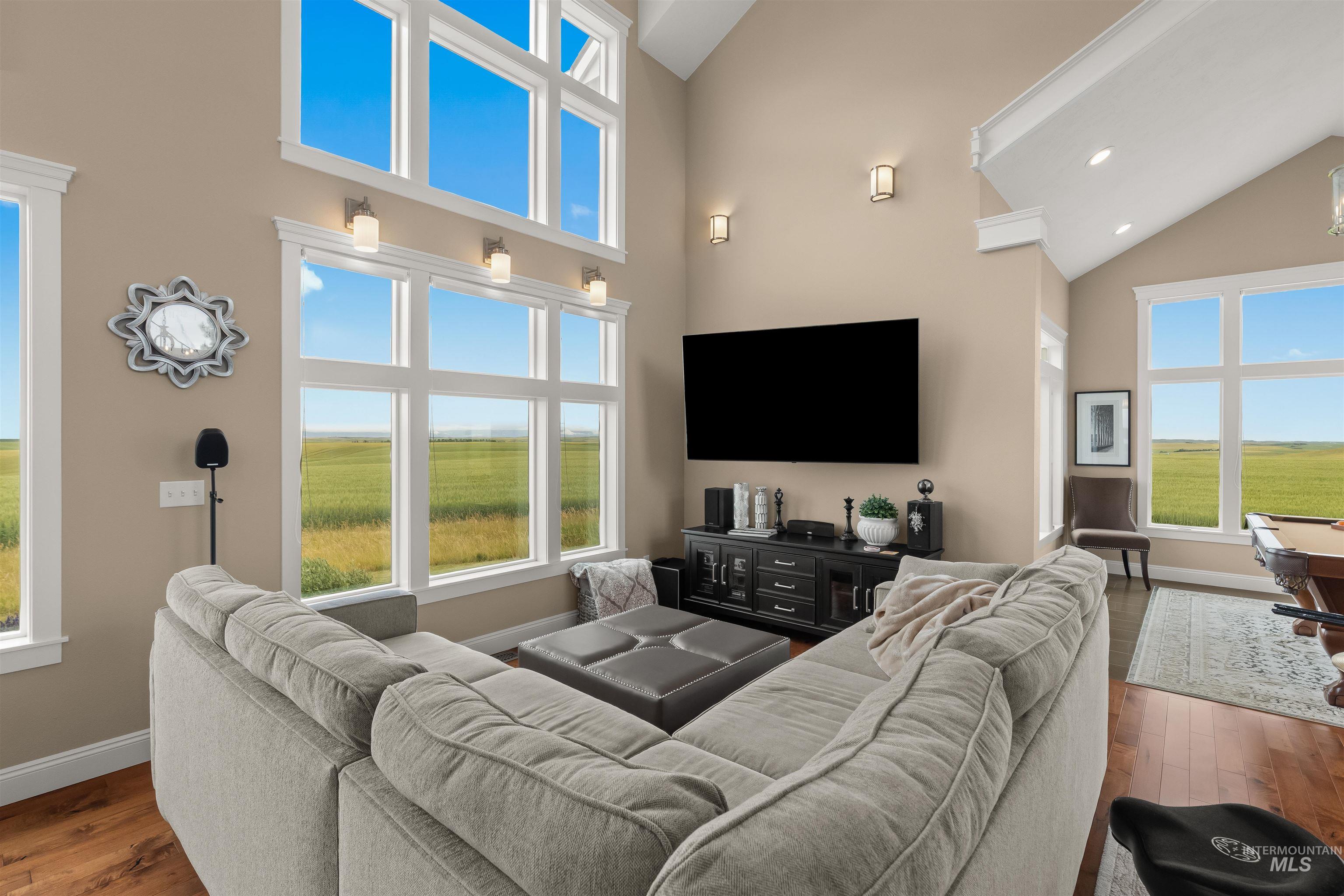 1513 Uniontown Road Genesee, ID 83832 - Photo 6 of 50 Grand entry featuring a two-story staircase with decorative wrought iron balusters and wood-finish treads