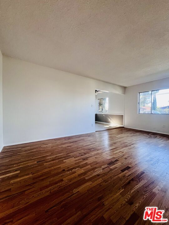 6610 Whitsett Avenue, Unit 1 North Hollywood, CA 91606 - Photo 2 of 11 a view of empty room with window and wooden floor