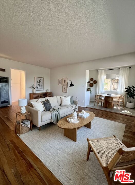 6610 Whitsett Avenue, Unit 1 North Hollywood, CA 91606 - Photo 3 of 11 a living room with furniture and wooden floor