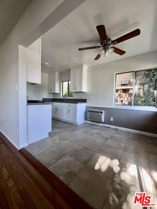 6610 Whitsett Avenue, Unit 1 North Hollywood, CA 91606 - Photo 10 of 11 a kitchen with stainless steel appliances granite countertop a sink stove and white cabinets