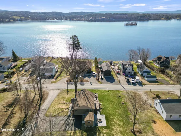 a view of a lake with a table and chairs
