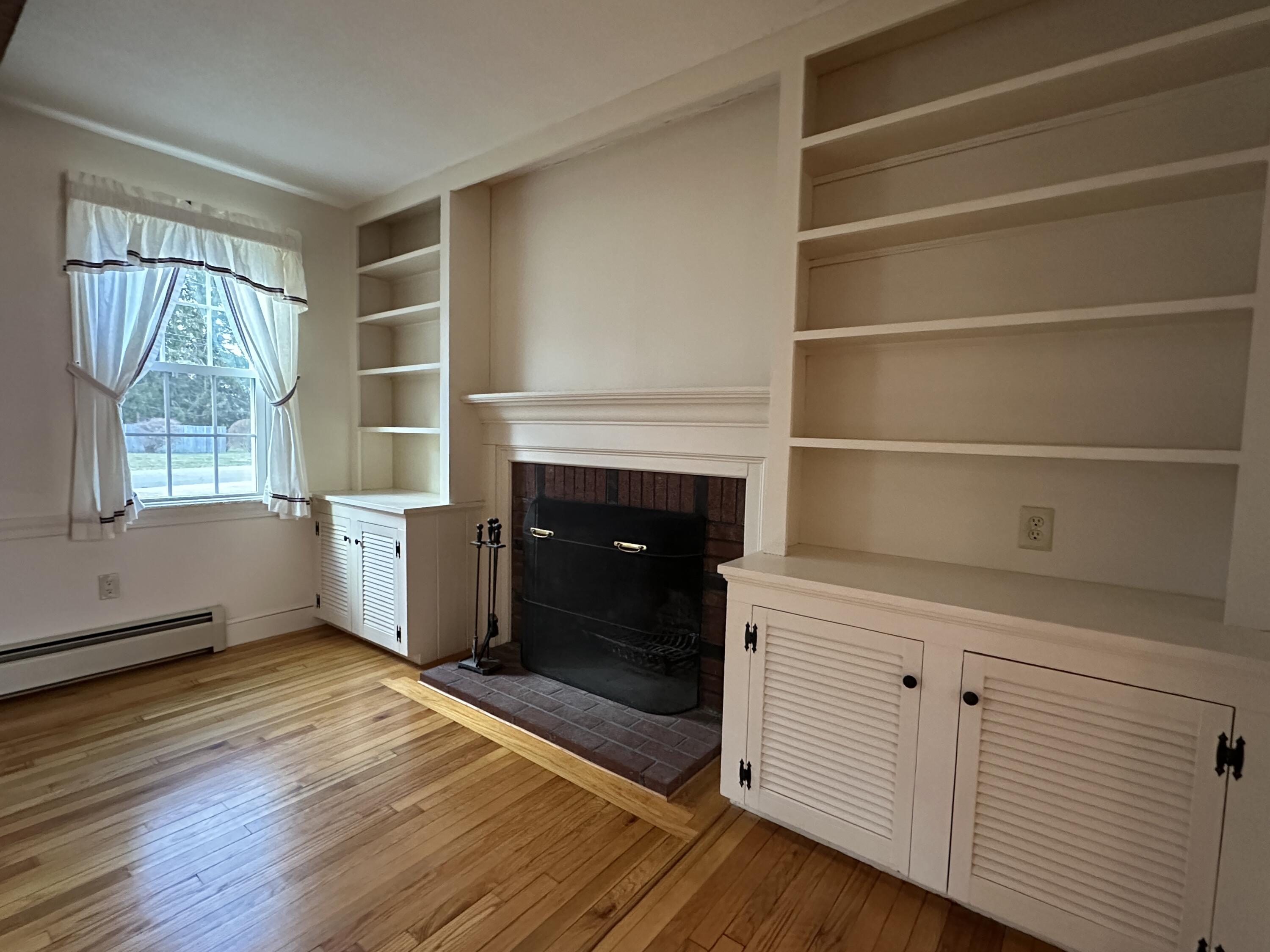 1 Pine Ridge Road Saco, ME 04072 - Photo 10 of 54 fireplace vieww with cabinetry and windo