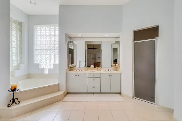a bathroom with a tub sink and mirror