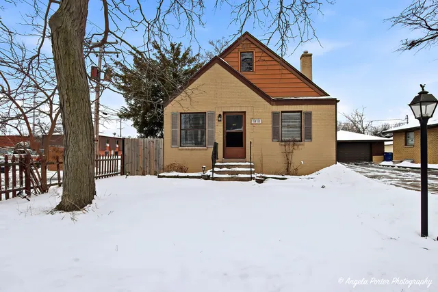 a view of a house with a yard covered in snow
