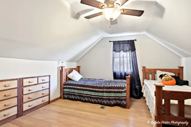 a bedroom with furniture and wooden floor