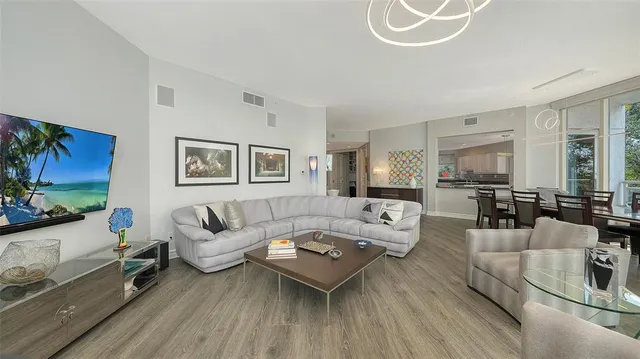 a kitchen with stainless steel appliances kitchen island granite countertop a dining table chairs and granite counter tops