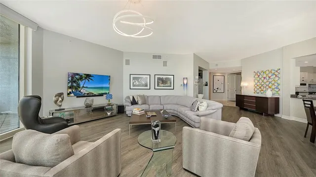 a kitchen with stainless steel appliances granite countertop a sink stove and white cabinets