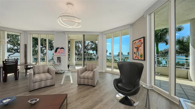 a view of a patio with table and chairs potted plants with wooden floor and fence