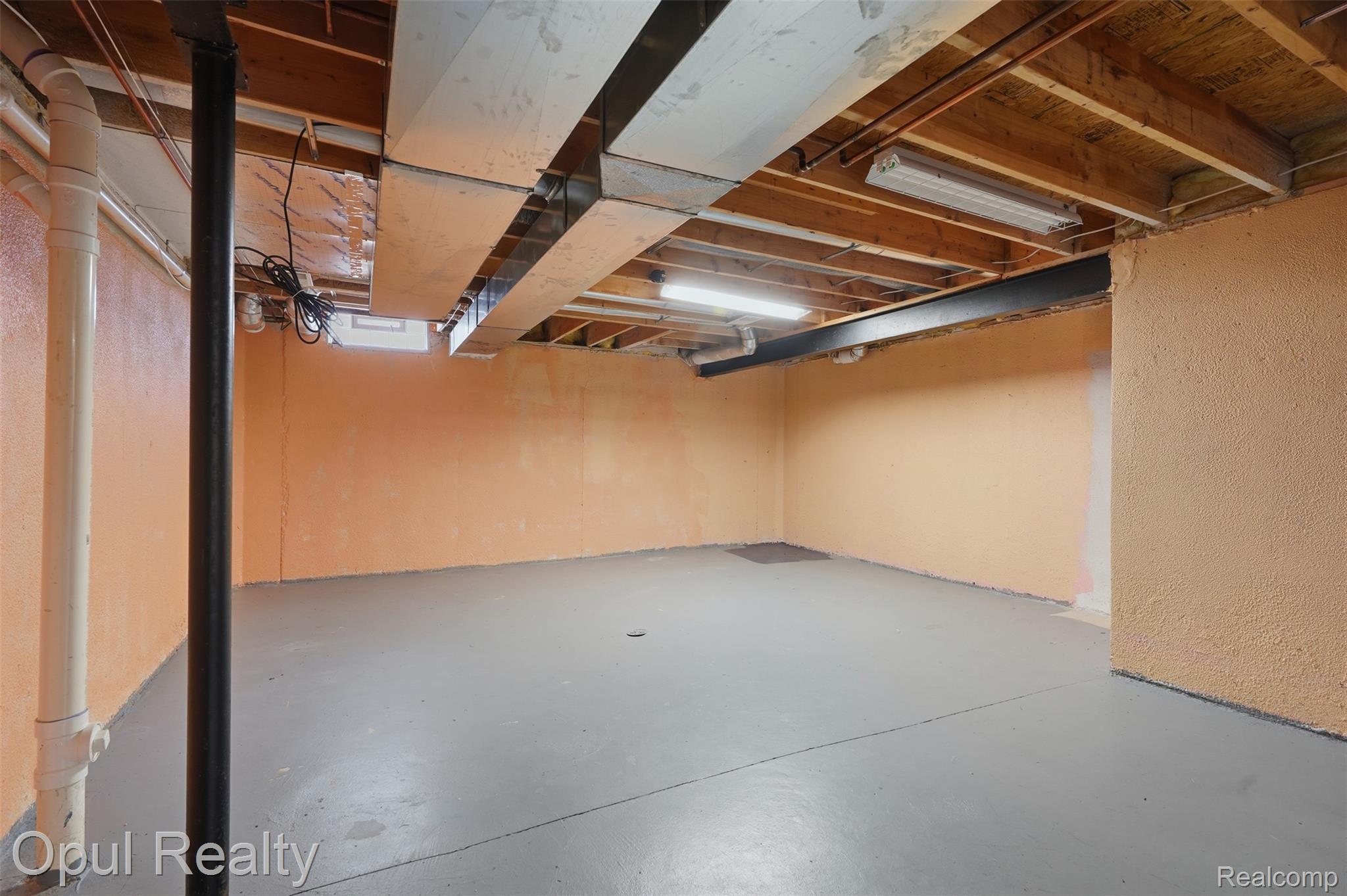 4530 Pond Run Canton, MI 48188 - Photo 36 of 43 Unfinished basement offering expansive open space, exposed ceiling joists, and a concrete floor