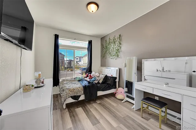 a bedroom with bed couch and window