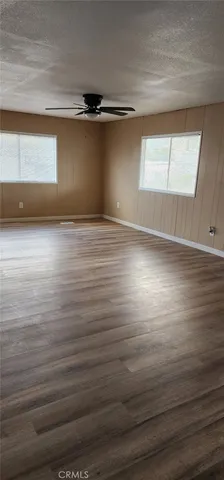 a living room with a window and a dresser