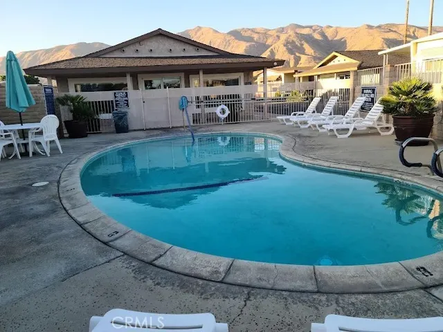 a view of a swimming pool with lounge chairs