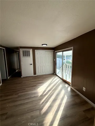 a view of an empty room with window and stairs