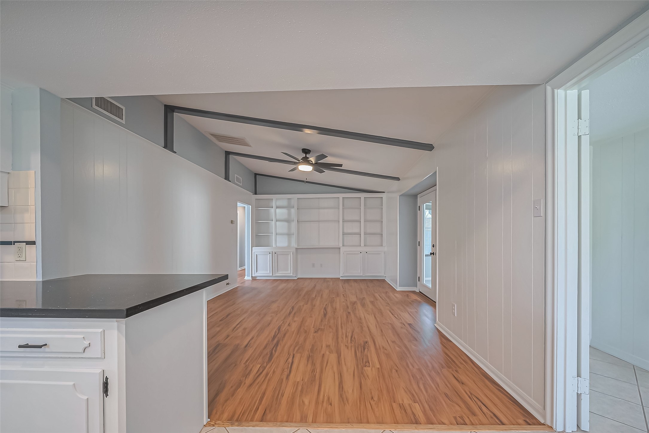 16506 Amcreek Road Houston, TX 77068 - Photo 15 of 50 a view of empty room with wooden floor and fan