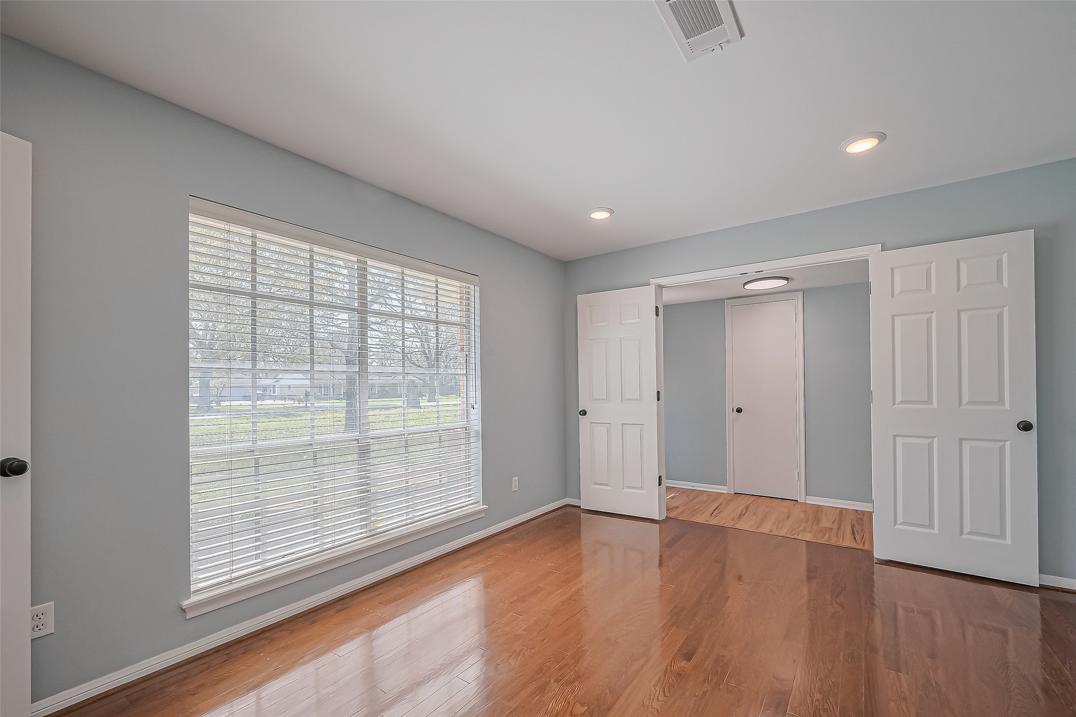 16506 Amcreek Road Houston, TX 77068 - Photo 18 of 50 a view of an empty room with wooden floor and a window