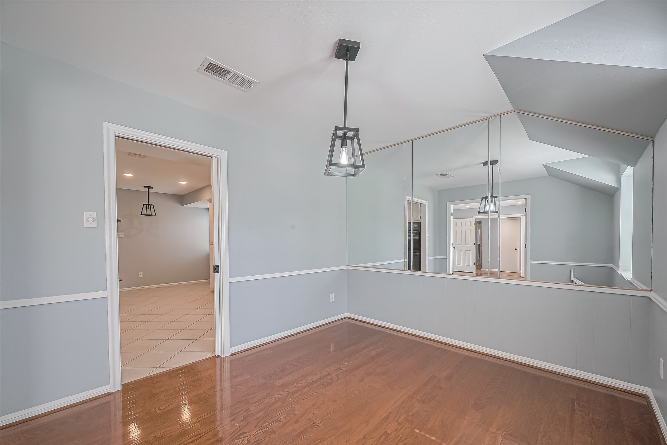 16506 Amcreek Road Houston, TX 77068 - Photo 19 of 50 an empty room with chandelier fan and windows