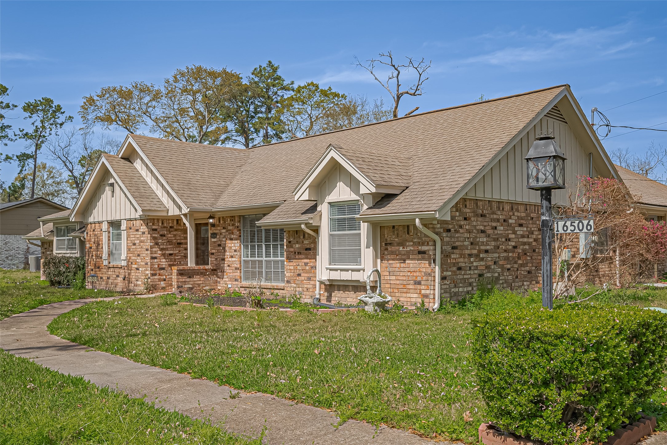 16506 Amcreek Road Houston, TX 77068 - Photo 2 of 50 a view of a big house with a big yard and large tree