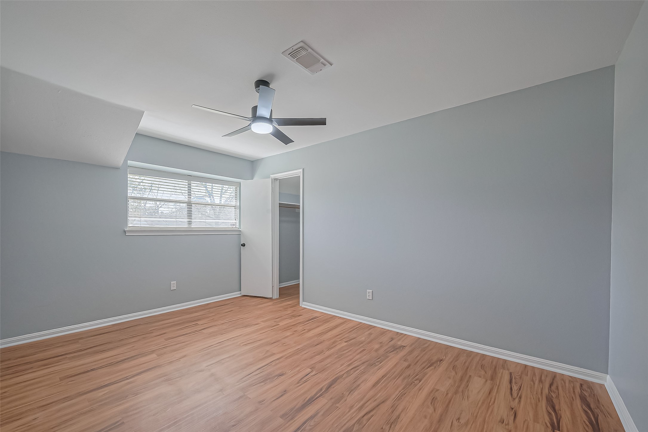 16506 Amcreek Road Houston, TX 77068 - Photo 28 of 50 a view of an empty room with wooden floor and a window