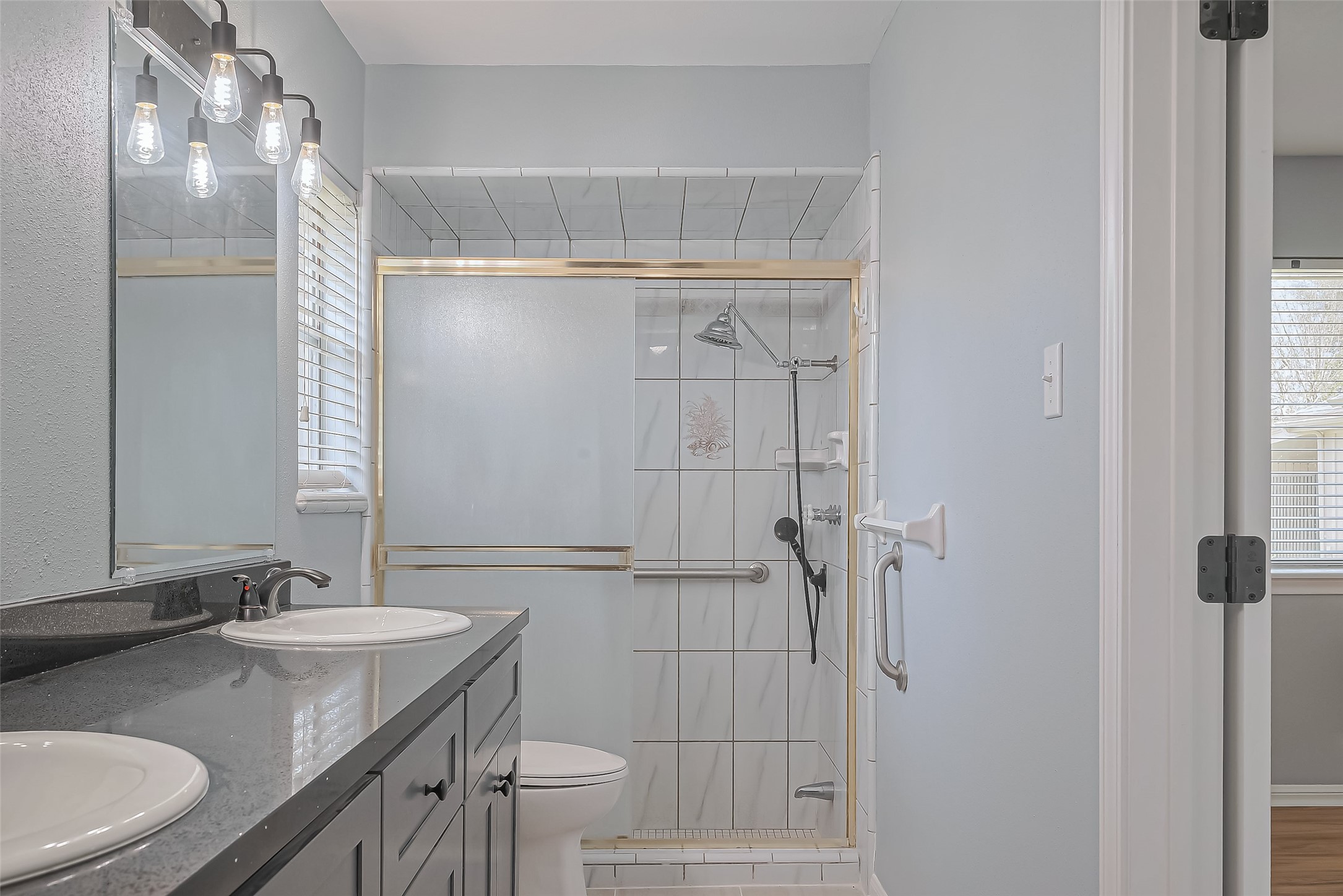 16506 Amcreek Road Houston, TX 77068 - Photo 36 of 50 a bathroom with a granite countertop sink a toilet and shower