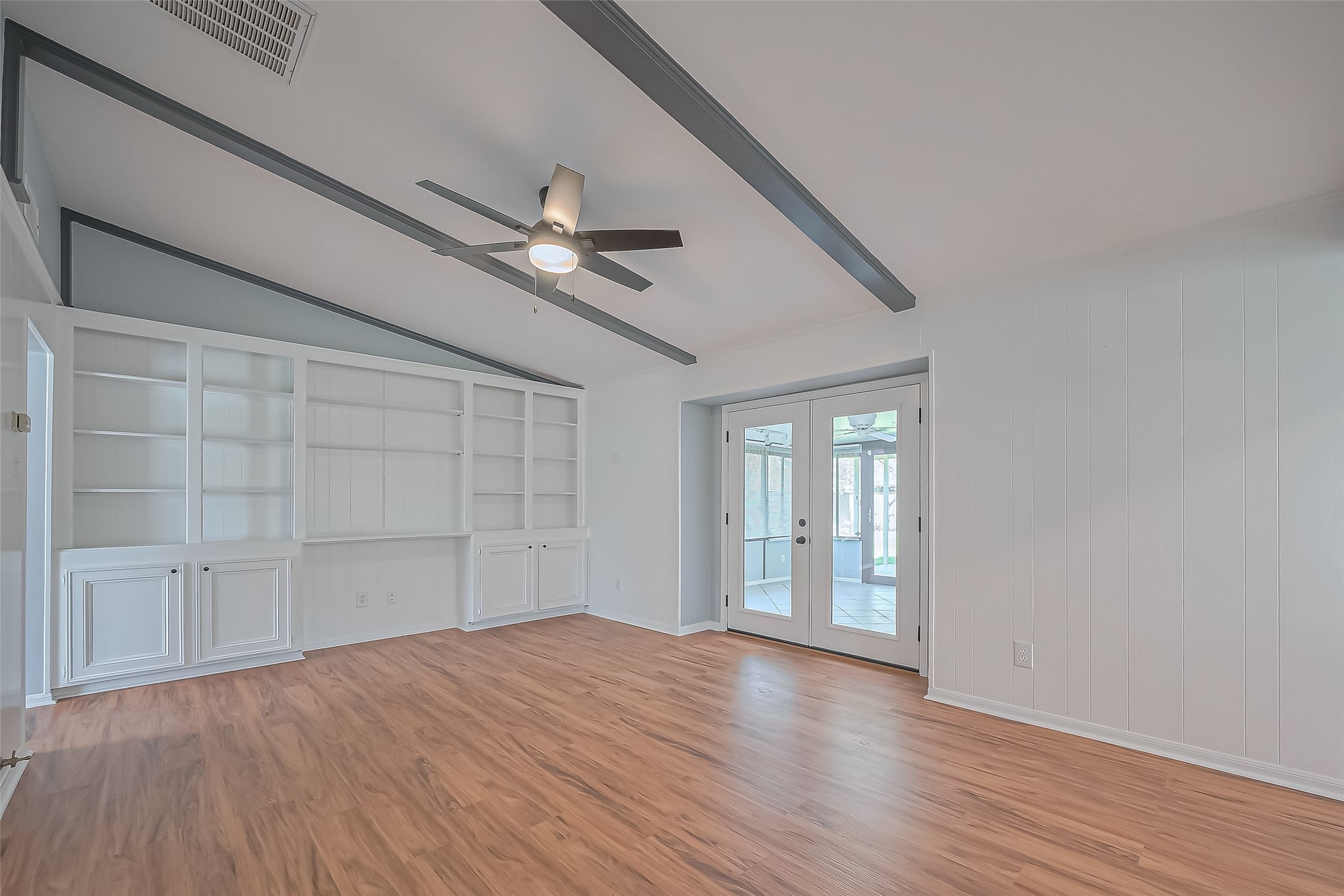 16506 Amcreek Road Houston, TX 77068 - Photo 6 of 50 a view of empty room with wooden floor and fan