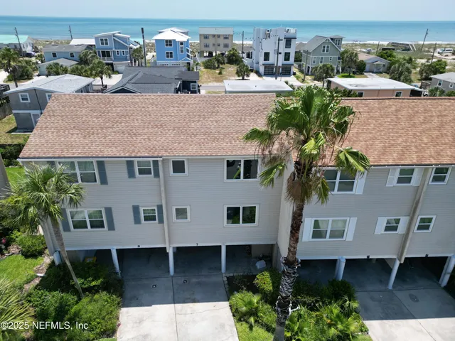 an aerial view of a house with yard and patio