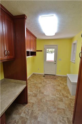 406 Cambridge Road Lebanon, TN 37087 - Photo 8 of 20 8x16 utility room has build-in cabinetry, utility sink and sewing desk.