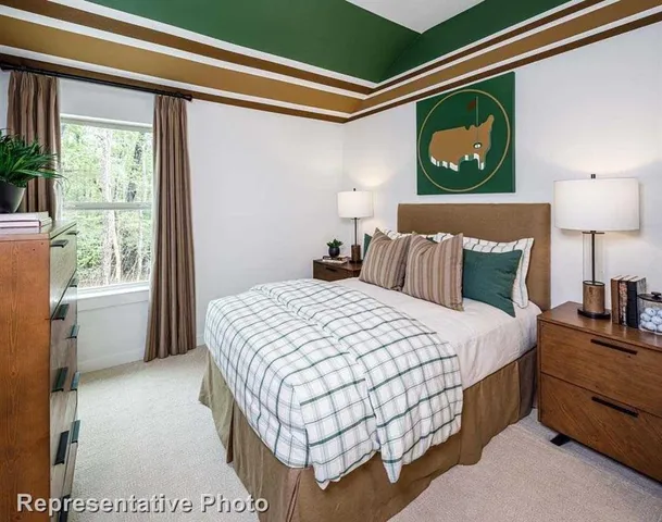 a bedroom with a bed and a night stand