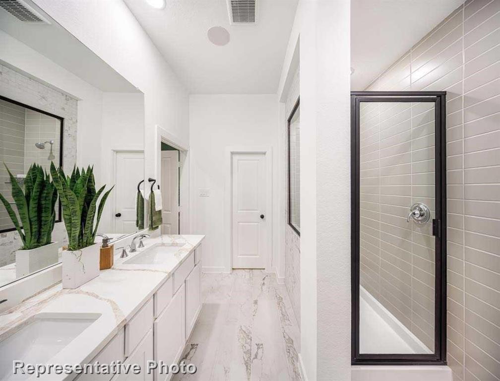1138 Morgan Drive Sherman, TX 75090 - Photo 5 of 21 a bathroom with a sink a mirror and a potted plant
