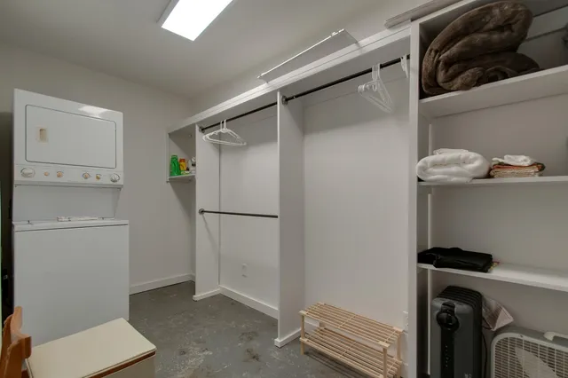 a view of storage and utility room with refrigerator and washer