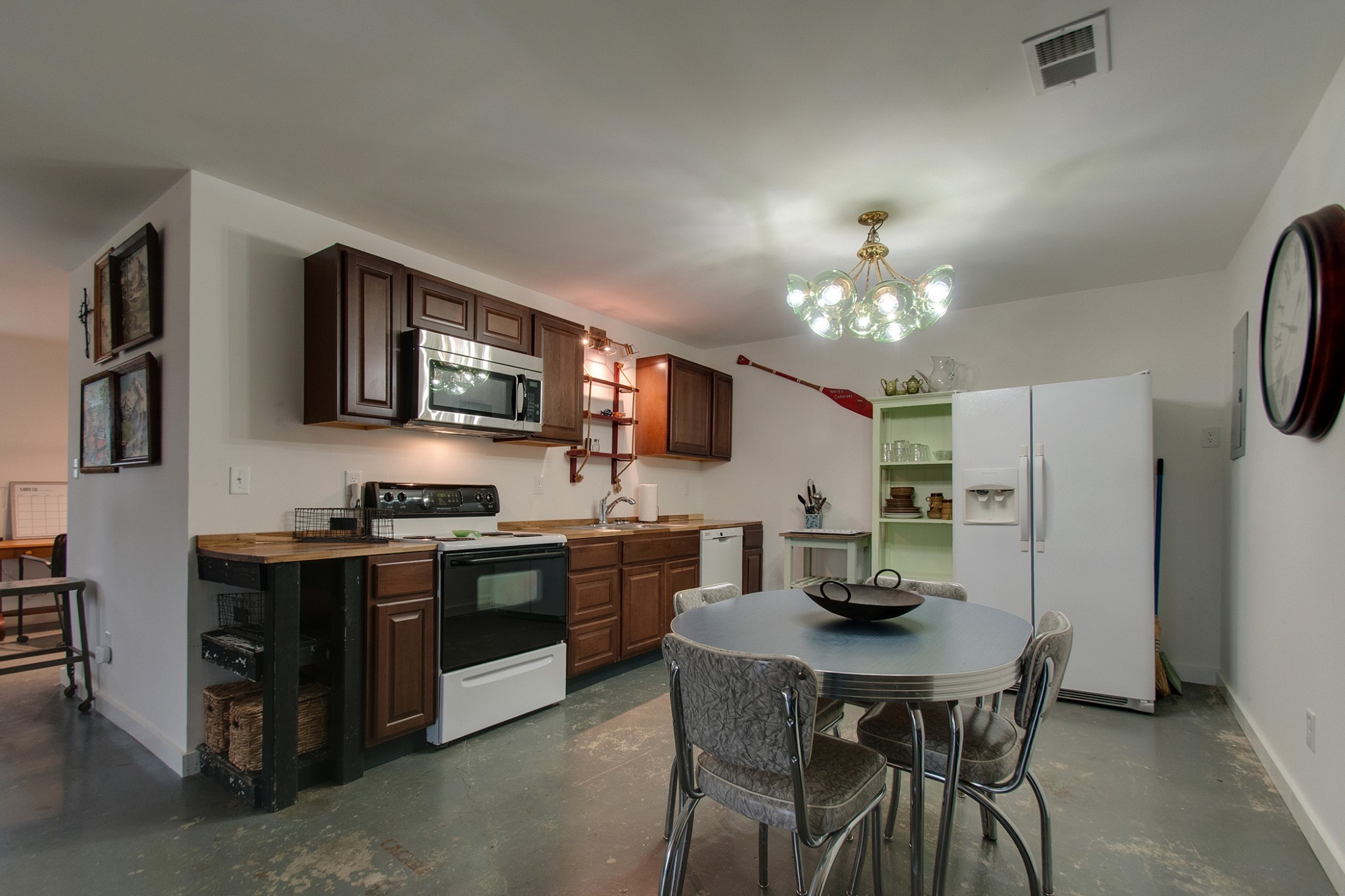 0 Cedar Hill Road Kingston Springs, TN 37082 - Photo 2 of 17 a kitchen with stainless steel appliances granite countertop a stove top oven a refrigerator a sink dishwasher a dining table and chairs with wooden floor