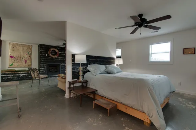 a bedroom with a bed furniture and a window