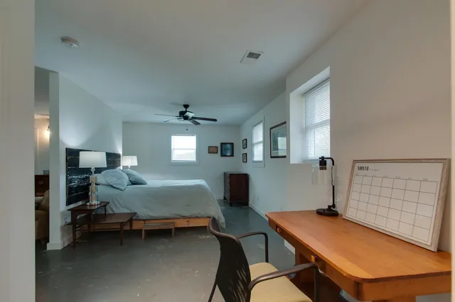 a bedroom with a bed and a desk